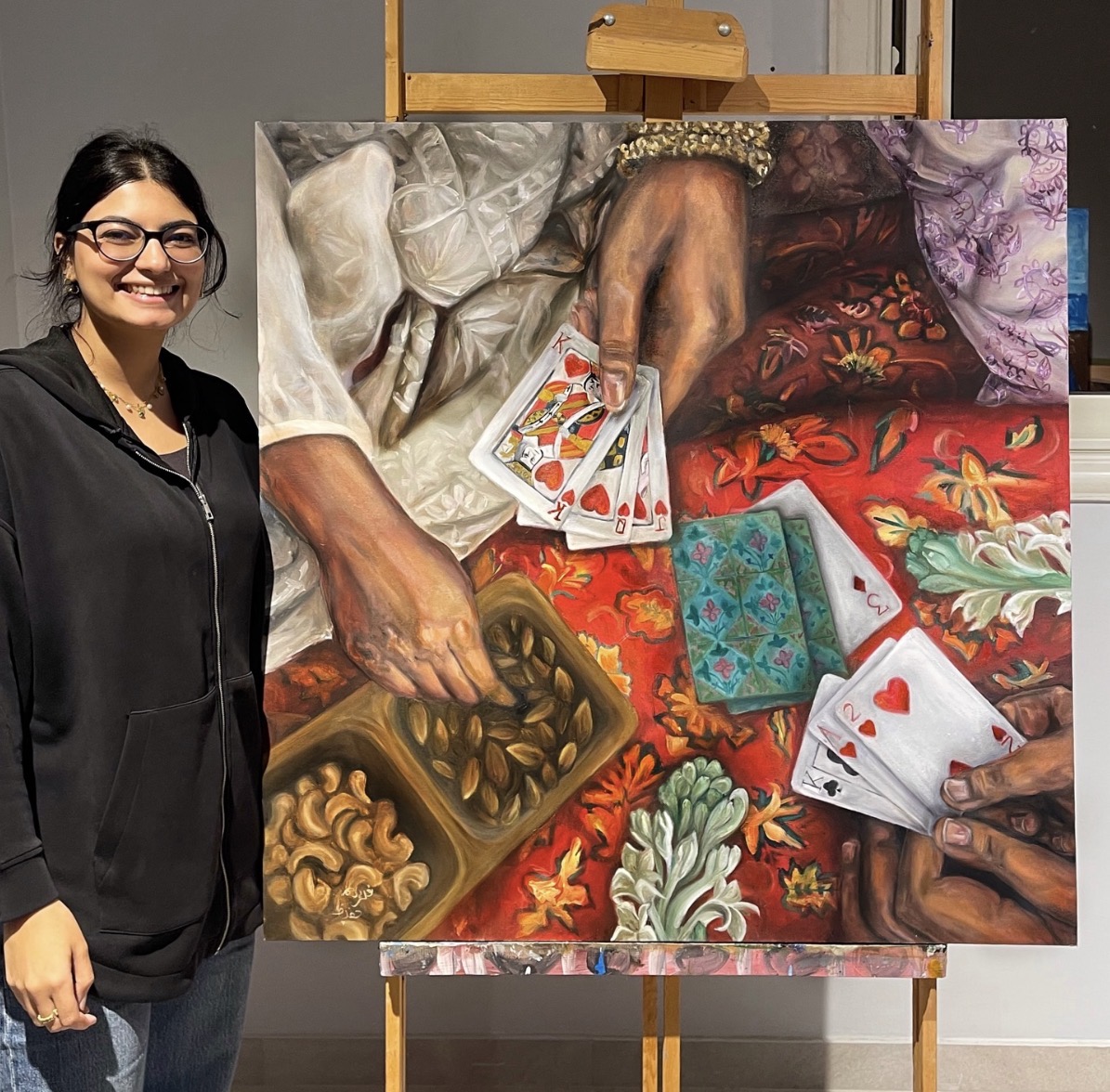 Student beside a large detailed figurative painting